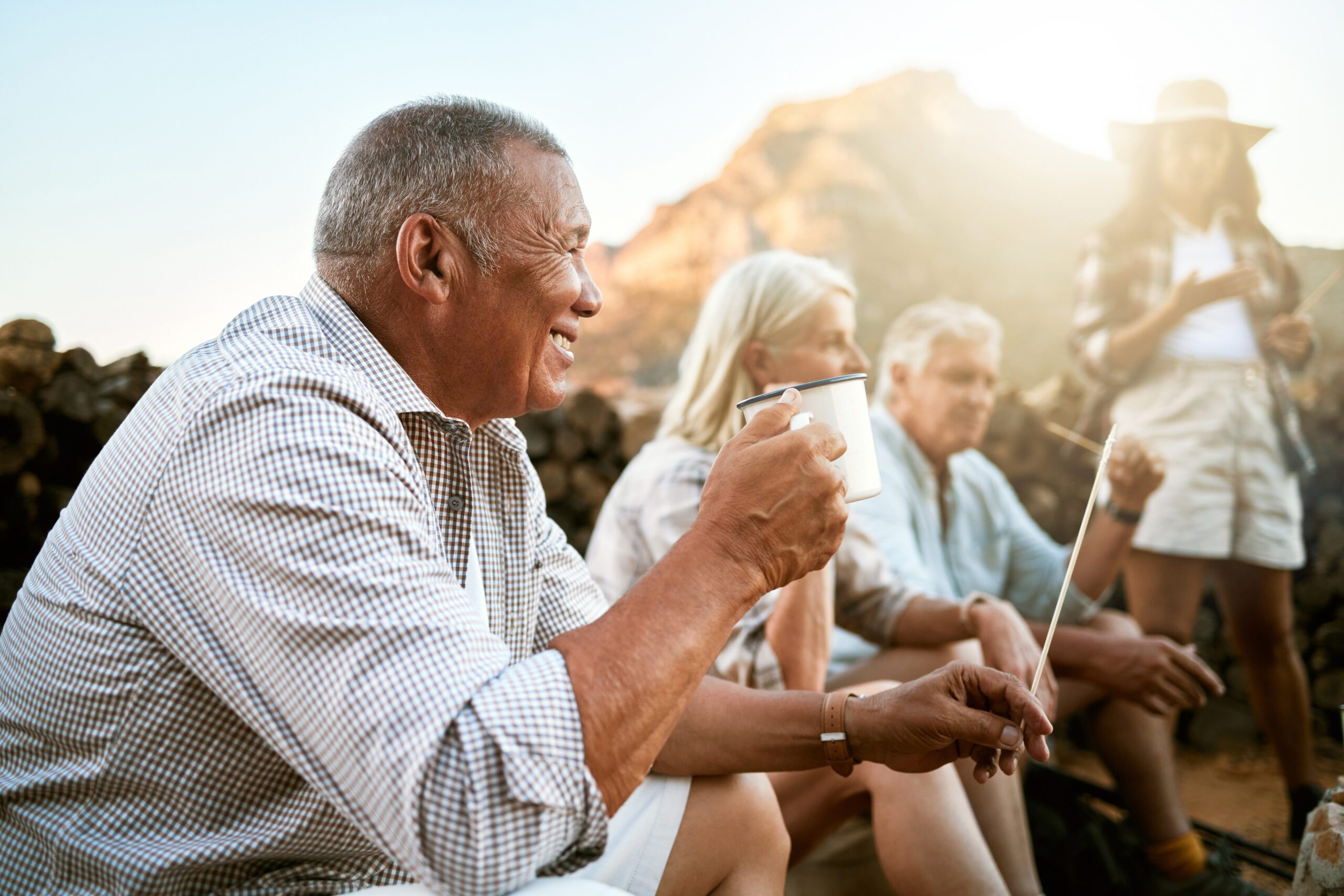 Image of a man holding a cup happy and relaxing indicating that he has reformed from healthcare to selfcare